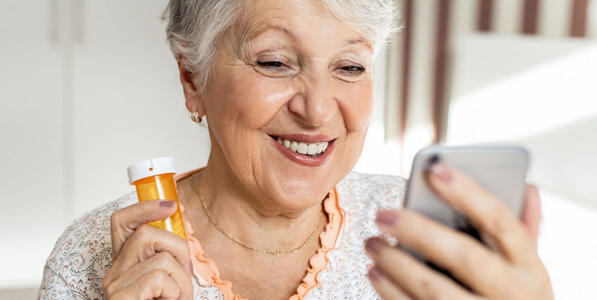 older-woman-using-phone-medication
